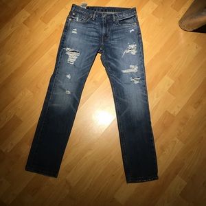 Levi’s 511 tattered, holey, jeans.